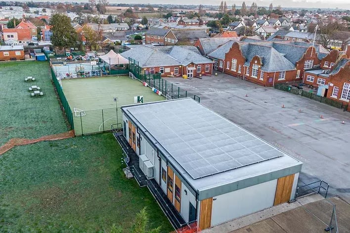 Modular buildings for schools which have been installed in a school next to a football pitch.