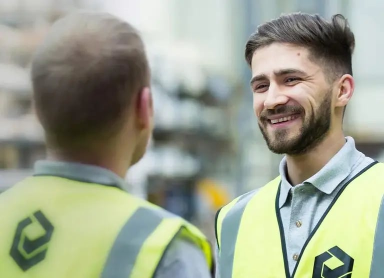Elite Systems GB employee waering a high visability vest, smiling