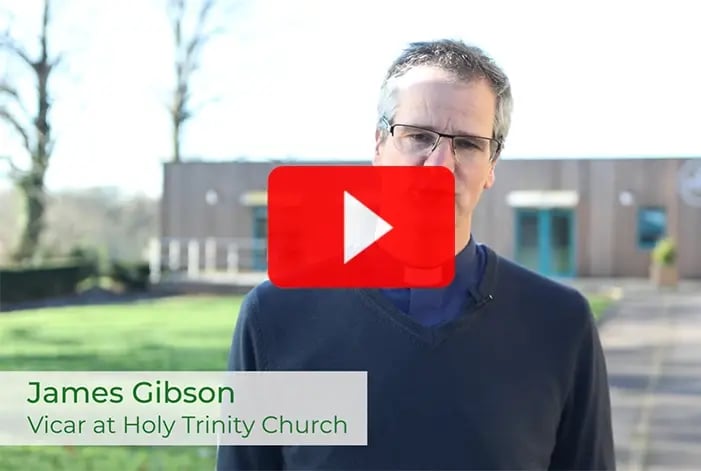 Vicar James Gibson standing in front of Holy Trinity Church,  sharing his journey of delivering a new modular community centre with Elite Systems 