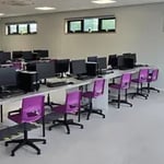 Modern modular IT classroom with computer workstations, desks and chairs designed for digital learning.