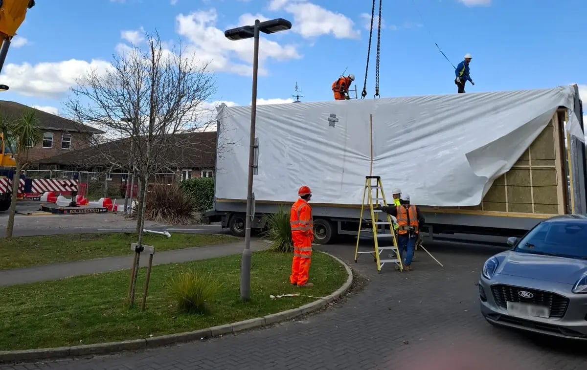 Delivery of a prefabricated module for the temporary decant modular mortuary facility at St Richard's Hospital before crane installation as part of the hospital redevelopment project.