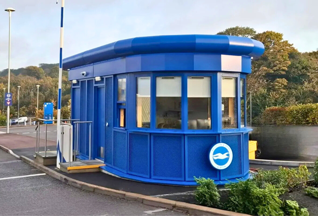 Modern modular security site canteen with tables, chairs and kitchen facilities, showing how well-equipped welfare buildings support construction teams.