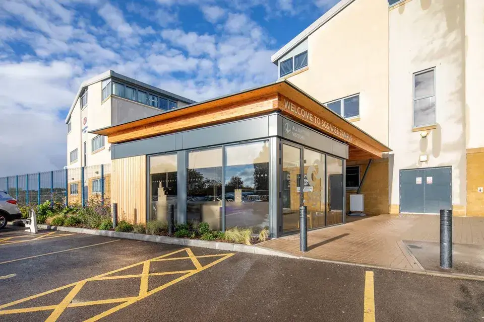 Permanent modular reception building integrated within an existing operational education campus