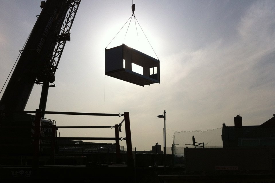 A crane lowering a modular building at South Norwood