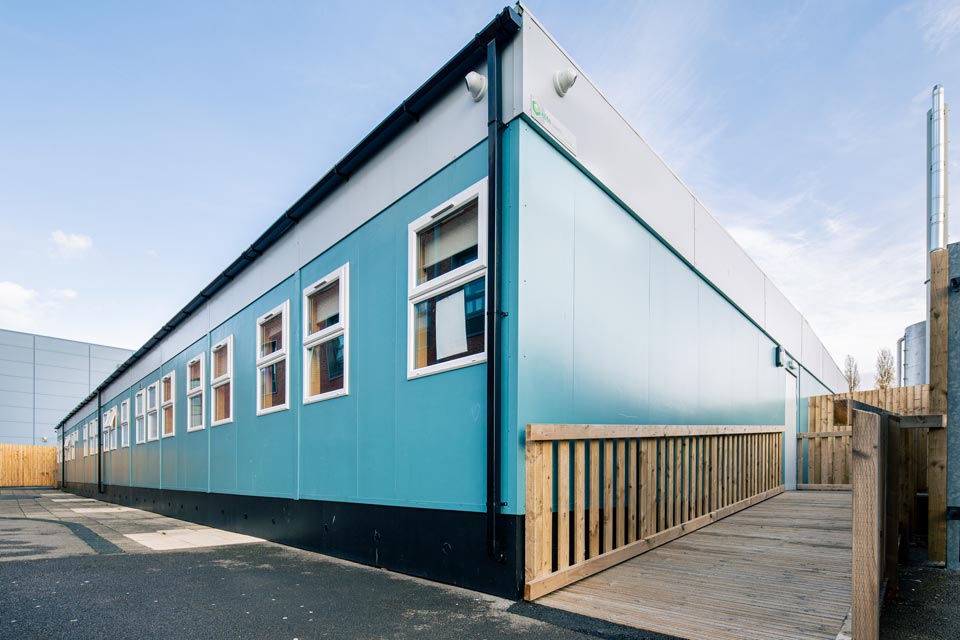 Denton Community College';s new buiding in a bright blue colour with white uPVC windows