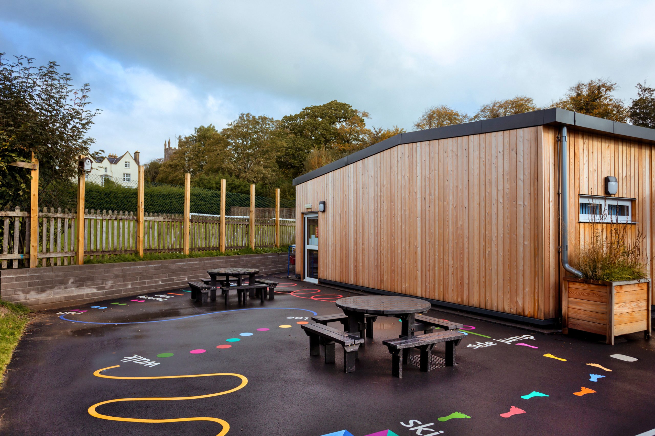 Pilton Infants School red cedar clad building with play ground outdoor space in foreground